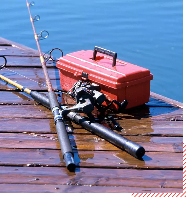 A red box with fishing rods and reels on it.